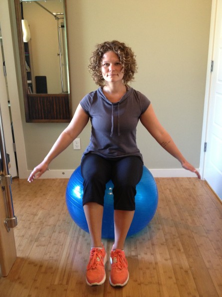 Single leg seated balance exercise on physio ball.